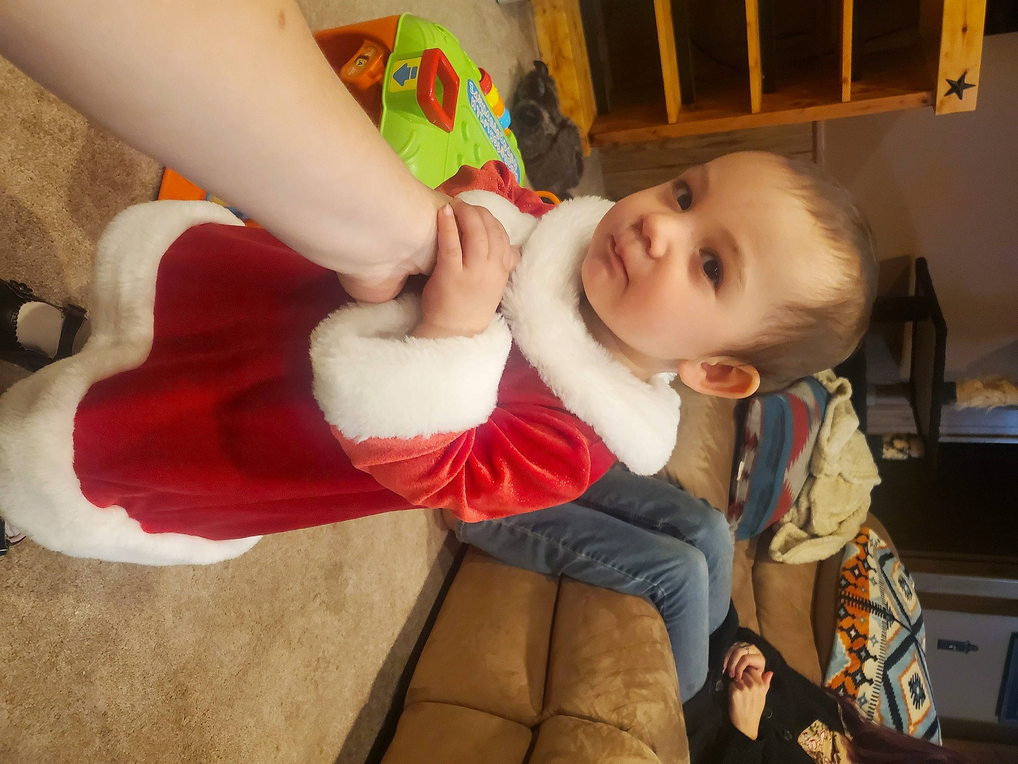 Ella is registered to the contest to win money with this photo: baby, child, christmas, comfort, couch, finger, fun, fur, happy, holiday, human_leg, lap, leg, nail, person, room, sitting, smile, thigh, thumb