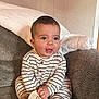 Rhett joined the competition — help win amazing prizes! baby, infant, six_months, striped_pajamas, couch, blanket, wooden_sign, milestone, cute, smiling, sitting, indoors, child, happy, face, feet, hand, clothing, portrait, home