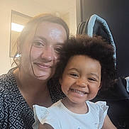 Adr participe au concours pour gagner de l'argent avec cette photo : child, woman, smile, happy, indoor, portrait, afro_hair, casual_clothing, white_shirt, black_and_white_pattern, face, female, toddler, person, hair, closeup, seated, light, window, furniture