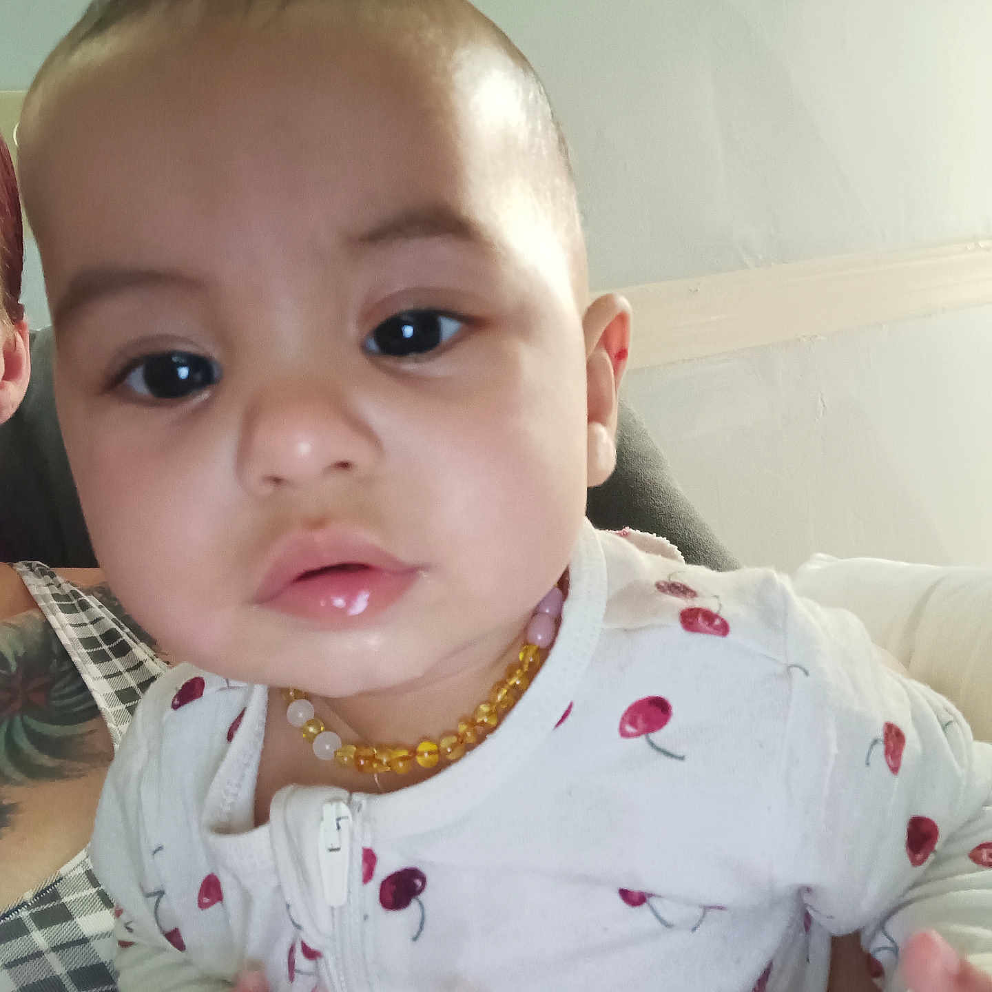 Royalty joined the competition — help win amazing prizes! adult_partial, baby, cherry_pattern, child, closeup, clothing, curious, expression, face, hand, head, indoor, infant, jewelry, necklace, onesie, person, portrait, skin, young