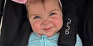 Emmy joined the competition — help win amazing prizes! baby, child, stroller, pink_bow, headband, blue_outfit, rainbow_pattern, face, smile, straps, safety_harness, infant, person, cute, outdoor, expression, cheeks, seat, clothing, portrait