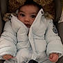 baby, child, winter_coat, fur_hood, bundle, car_seat, clothing, cute, face, infant, jacket, looking, person, portrait, seat, small_hands, warm, winter, young, zipper