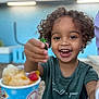 Noah joined the competition — help win amazing prizes! casual_clothing, child, closeup, cup, curly_hair, daylight, food, fun, gummy_candy, happy, ice_cream, joy, outdoor, playful, portrait, shaved_ice, smiling, summer, table, toddler