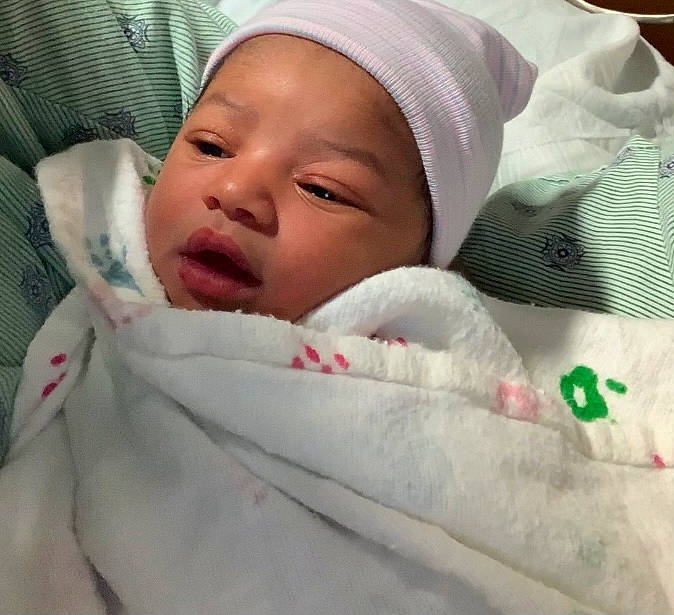 Emani joined the competition — help win amazing prizes! baby, baby_products, baby_safety, baby_sleeping, baby_toddler_clothing, bedding, bedtime, blanket, cheek, child, comfort, eyebrow, hat, linens, nap, nose, person, room, skin, textile