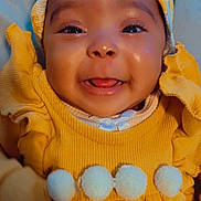 Mya is registered to the contest to win money with this photo: baby, bodypart, bonnet, cap, clothing, face, finger, hand, happy, hat, head, hood, hoodie, knitwear, person, photography, portrait, smile, sweater, sweatshirt