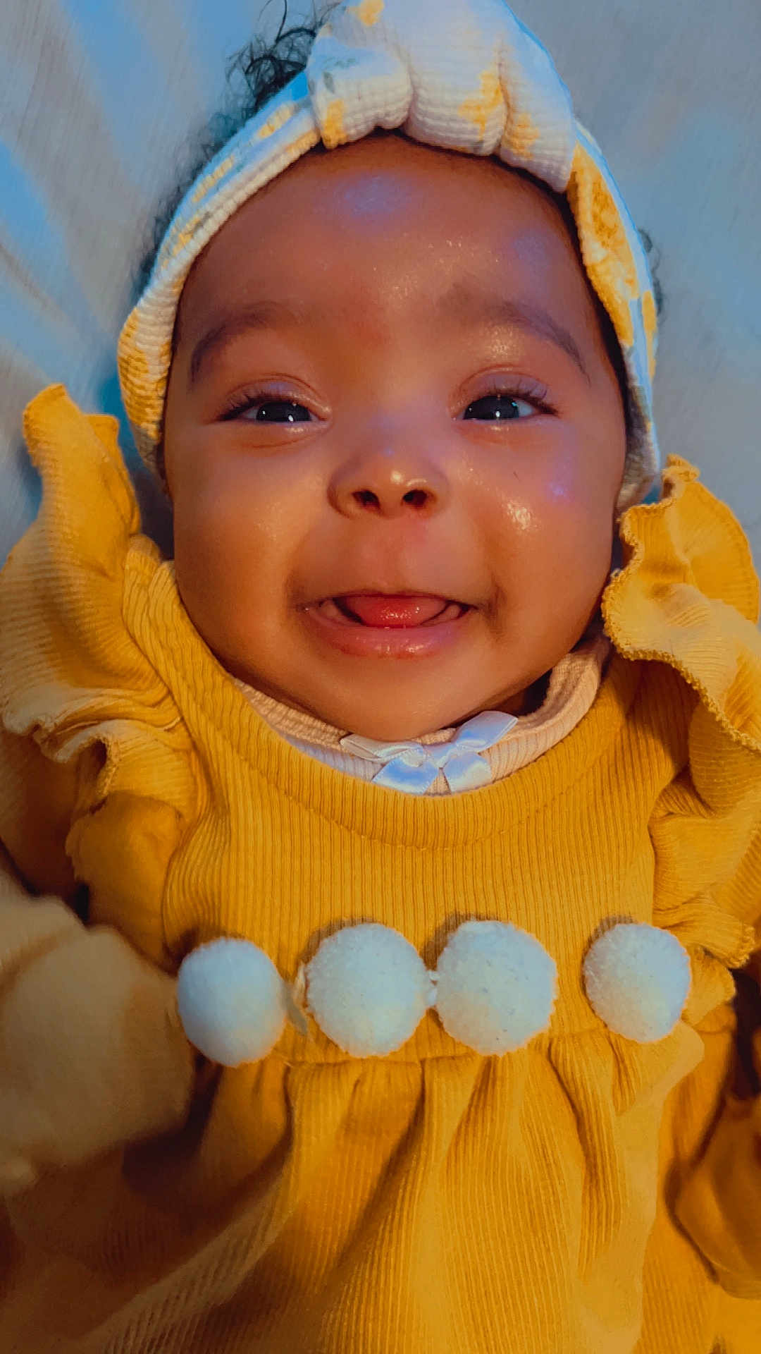 Mya is registered to the contest to win money with this photo: baby, bodypart, bonnet, cap, clothing, face, finger, hand, happy, hat, head, hood, hoodie, knitwear, person, photography, portrait, smile, sweater, sweatshirt