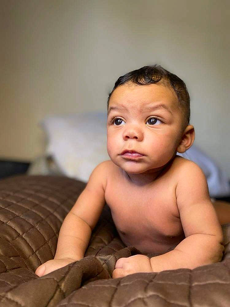 Kashton is registered to the contest to win money with this photo: arm, baby, baby_toddler_clothing, barechested, cheek, chest, comfort, eye, eyebrow, eyelash, flash_photography, happy, iris, lip, neck, nose, person, shoulder, sitting, stomach