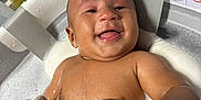 Zion is registered to the contest to win money with this photo: baby, bath, water, foam, happy, smile, skin, bracelet, infant, child, sitting, wet, cute, playful, indoors, tub, foam_bubbles, human, joyful, relaxation