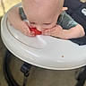 baby, child, watermelon, high_chair, eating, food, hands, face, head, skin, furniture, indoor, cute, infant, person, closeup, table, seat, caucasian, healthy