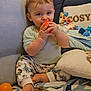 Mariùs participe au concours pour gagner de l'argent avec cette photo : baby, blanket, child, cozy, cute, face, foot, hand, home, indoor, orange_ball, patterned_clothing, pillow, play, sitting, smiling, soft_toys, stuffed_animal, toddler, toy
