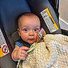 Zachary joined the competition — help win amazing prizes! baby, infant, car_seat, blanket, toy, child, face, hand, curious, wide_eyes, indoor, seat_belt, warning_label, fabric, clothing, head, person, sitting, cute, portrait