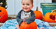 Zachary joined the competition — help win amazing prizes! baby, pumpkin, blanket, outdoor, smiling, cute, fall, autumn, carved_pumpkin, orange, grass, plant, pottery, child, happy, sitting, seasonal, holiday, portrait, nature
