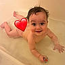 baby, bathtub, water, wet_hair, smile, rubber_ducky, child, bath_time, cute, infant, playful, splashing, happy, skin, naked, bathroom, toy, young_child, cheerful, face