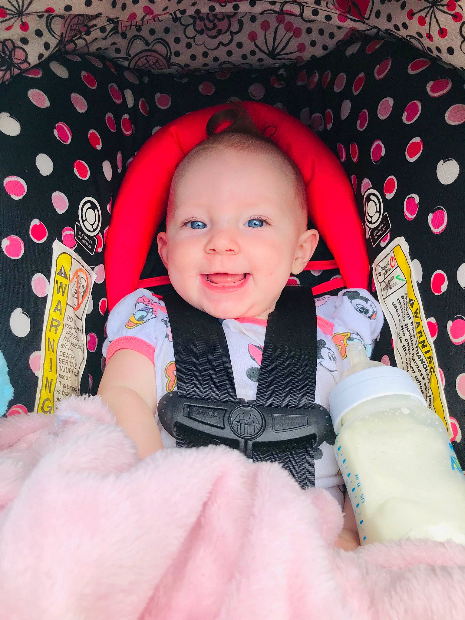 Liberty is registered to the contest to win money with this photo: baby, baby_toddler_clothing, cheek, child, comfort, eye, facial_expression, finger, flash_photography, happy, human_body, magenta, pattern, person, pink, product, skin, sleeve, smile, textile