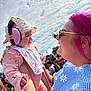 Love joined the competition — help win amazing prizes! baby, pink_ear_protectors, hat, bib, woman, pink_hair, sunglasses, smile, outdoor, crowd, daylight, blue_sky, clouds, floral_dress, holding, happy, people, festival, portrait, event