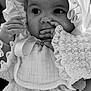 Love is registered to the contest to win money with this photo: baby, infant, child, black_and_white, close_up, bonnet, lace, clothing, portrait, hand, face, cute, innocence, young_child, fashion, soft_texture, expression, adorable, person, detail