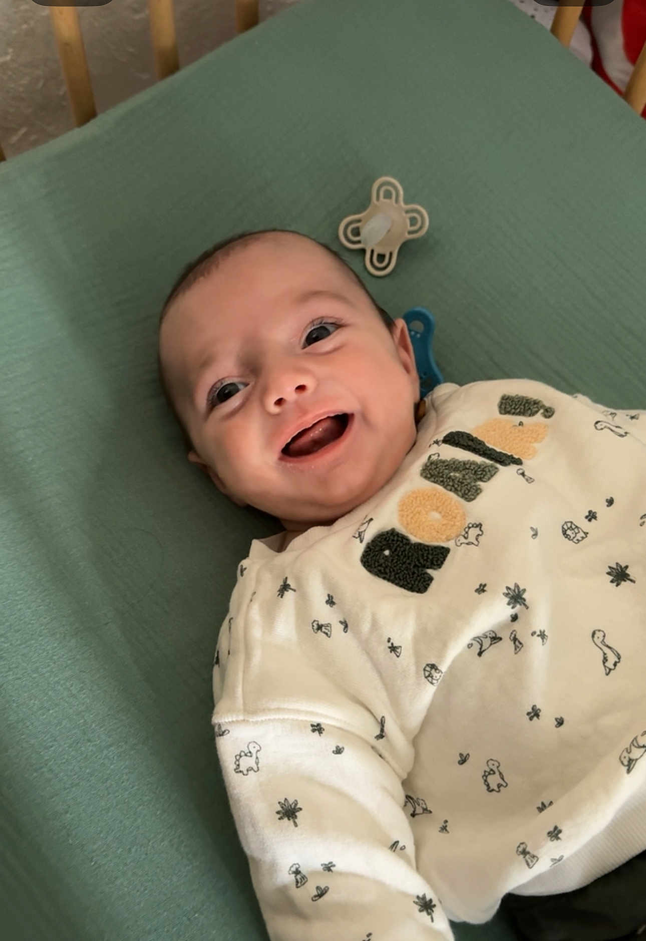 Lyam participe au concours pour gagner de l'argent avec cette photo : baby, smiling, infant, blanket, pacifier, white_sweater, patterned_clothing, lying_down, happy, cute, child, indoors, face, young_child, apparel, baby_clothes, portrait, expression, cozy, resting