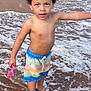 Bleu Enzo Caban is registered to the contest to win money with this photo: child, beach, water, ocean, sand, waves, swim_trunks, toy, pink, curly_hair, barefoot, summer, outdoor, person, playing, shore, splash, happy, young, nature