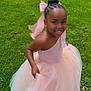 child, girl, smiling, dress, pink_dress, tulle, bow, braided_hair, grass, outdoor, happy, joyful, nature, greenery, portrait, fashion, cute, playful, one_person, celebration