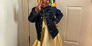 Dalia Ann joined the competition — help win amazing prizes! brown_sandals, casual, child, colorful_hair_accessories, cute, denim_jacket, door, fashion, girl, hair_bows, happy, indoors, peace_sign, person, portrait, posing, smiling, standing, wood_floor, yellow_dress