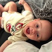 Remi joined the competition — help win amazing prizes! baby, infant, smiling, lying_down, clothing, blanket, pillow, face, cheerful, indoors, cute, happy, soft_texture, toddler, person, closeup, skin, mouth_open, head, eyes