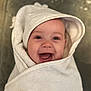 Remi is registered to the contest to win money with this photo: baby, towel, hood, smiling, happy, face, child, wrapped, infant, cute, skin, eyes, mouth, expression, indoors, blanket, soft, portrait, young, person