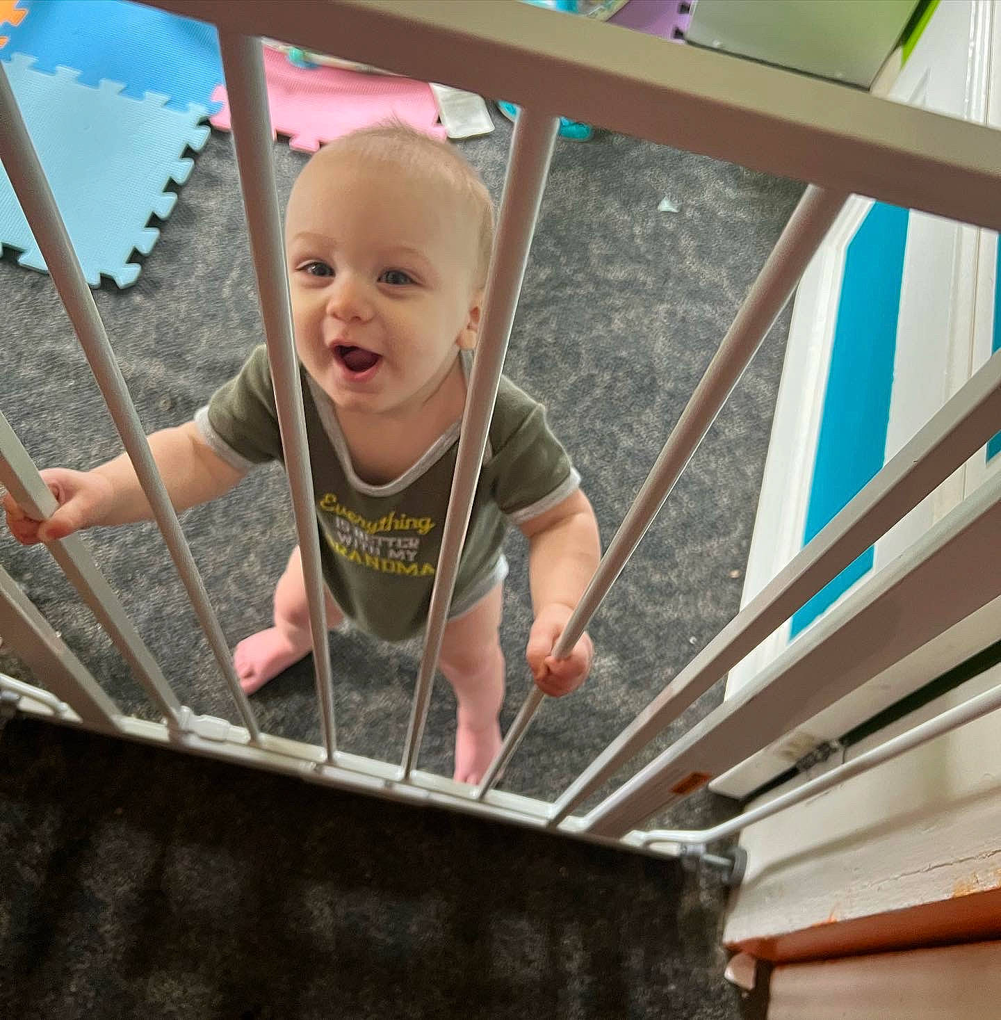 Gordon is registered to the contest to win money with this photo: baby, baby_toddler_clothing, child, city, fun, grass, happy, leisure, line, person, play, product, sitting, smile, stairs, standing, t_shirt, toddler, vacation, white