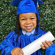 Noah joined the competition — help win amazing prizes! child, smiling, graduation, cap, gown, diploma, portrait, celebration, happy, young, education, achievement, outdoor, greenery, person, headwear, holding, blue, closeup, formal