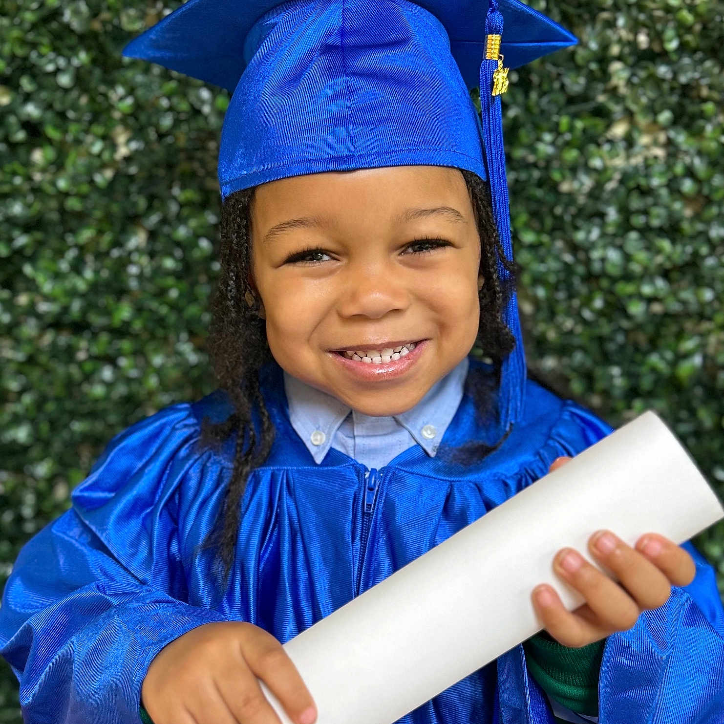Noah joined the competition — help win amazing prizes! achievement, blue, cap, celebration, child, closeup, diploma, education, formal, gown, graduation, greenery, happy, headwear, holding, outdoor, person, portrait, smiling, young