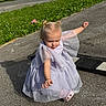 Chloe is registered to the contest to win money with this photo: toddler, child, dress, lavender, sparkly, pavement, shadow, grass, sunlight, outdoor, person, cute, fashion, playful, small_hands, hairstyle, two_buns, young_child, casual, summer