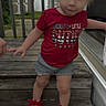 toddler, child, pigtails, blue_eyes, red_shirt, shorts, red_sneakers, wooden_steps, outdoor, backyard, shed, curious, standing, person, casual_clothing, daylight, smile, cute, young_child, portrait