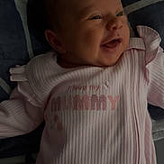 Amelia-Rose joined the competition — help win amazing prizes! baby, infant, smile, pink_clothing, blanket, lying_down, portrait, face, child, cute, happy, newborn, soft_lighting, text_on_clothing, fabric, home, closeup, person, sleepwear, cozy