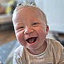 baby, smiling, child, infant, face, happy, mouth_open, indoor, clothing, cute, portrait, person, young_child, blonde_hair, cheerful, closeup, toddler, soft_light, casual, background_blur