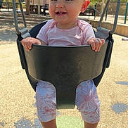 Addie joined the competition — help win amazing prizes! baby, child, swing, playground, outdoor, smiling, happy, sunlight, trees, person, legs, feet, clothing, seat, metal, park, daylight, fun, nature, play