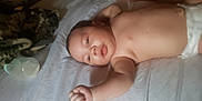 Angel joined the competition — help win amazing prizes! baby, infant, diaper, face, arm, hand, foot, bottle, blanket, bed, sheet, lying_down, skin, expression, curious, indoors, child, person, newborn, sleepwear