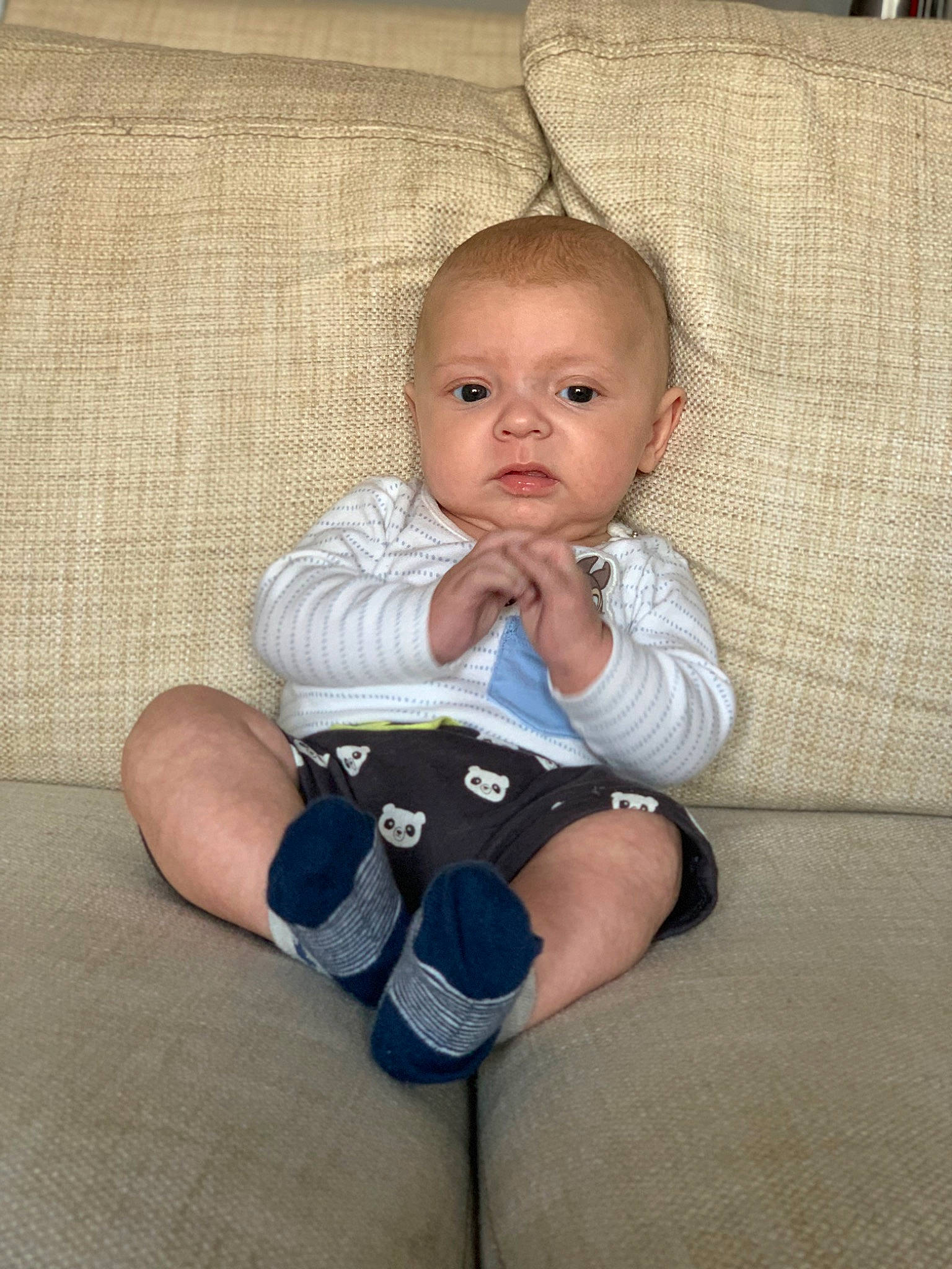 Taylor is registered to the contest to win money with this photo: baby, baby_toddler_clothing, cheek, comfort, elbow, eye, finger, flooring, foot, head, human_leg, knee, person, sitting, skin, sleeve, sock, textile, thigh, toddler