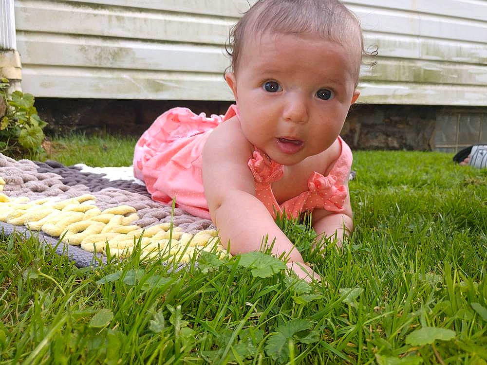 Alize joined the competition — help win amazing prizes! baby, cheek, child, face, finger, garden, grass, grass_family, hand, head, lawn, leaf, person, pink, plant, play, sitting, skin, summer, toddler