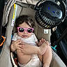 baby, infant, child, sunglasses, pink_sunglasses, car_seat, car, vehicle, fan, clip_on_fan, seated, indoor, portrait, fashion, summer, striped_clothing, barefoot, toys, travel, safety_seat