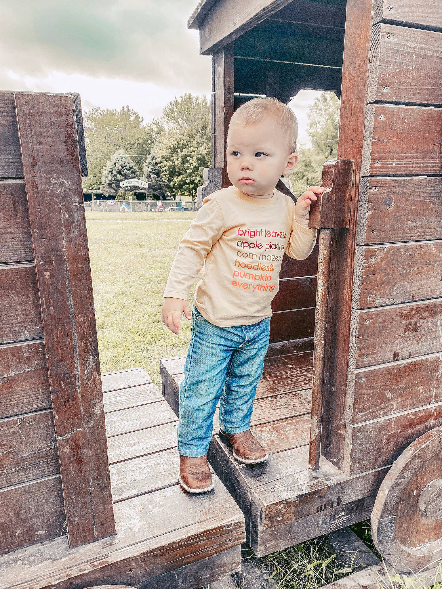 Bryer is registered to the contest to win money with this photo: brick, child, denim, grass, home, house, jeans, people, person, photograph, photography, plant, skin, standing, summer, textile, toddler, tree, vacation, wall