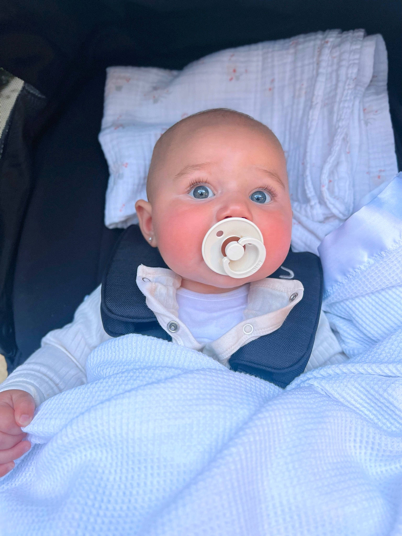 Emilia is registered to the contest to win money with this photo: baby, baby_products, baby_sleeping, baby_toddler_clothing, carmine, cheek, child, chin, comfort, eye, finger, head, human_body, iris, mouth, nose, person, sitting, skin, sleeve