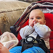 Phoebe is registered to the contest to win money with this photo: baby, blanket, bodypart, clothing, couch, cushion, face, finger, furniture, hand, happy, hat, head, homedecor, newborn, pants, person, photography, portrait, smile