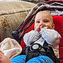 baby, blanket, bodypart, clothing, couch, cushion, face, finger, furniture, hand, happy, hat, head, homedecor, newborn, pants, person, photography, portrait, smile