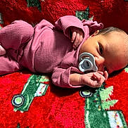 Samiya joined the competition — help win amazing prizes! newborn, baby, infant, pacifier, pink_pajamas, blanket, red_blanket, holiday_theme, christmas, resting, lying_down, soft_texture, cute, small_hands, face, head, sleepwear, child, indoors, cozy