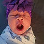 baby, yawning, headband, purple_flower, blanket, swaddle, sleepy, infant, closeup, face, mouth_open, adorable, cute, newborn, resting, soft_lighting, indoor, person, portrait, child