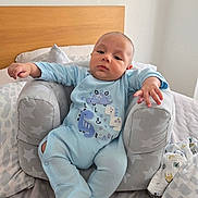 Ignacio joined the competition — help win amazing prizes! baby, baby_seat, bed, blanket, blue_clothing, child, cute, dinosaur, indoor, infant, newborn, onesie, person, pillow, portrait, relaxed, resting, sleepwear, soft_fabric, star_pattern