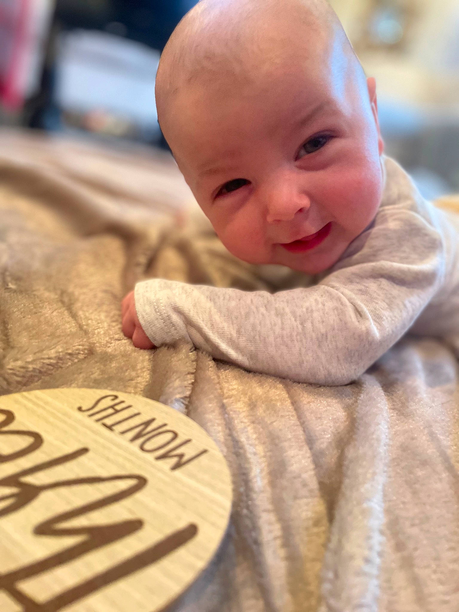 Luca is registered to the contest to win money with this photo: artifact, baby, baby_toddler_clothing, carmine, cheek, child, close_up, comfort, flooring, font, fur, linens, nose, person, room, sitting, skin, sleeve, smile, toddler