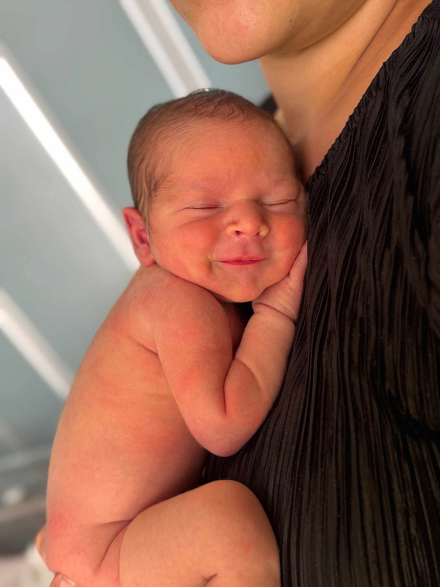 Adam participe au concours pour gagner de l'argent avec cette photo : newborn, baby, infant, sleeping, smiling, skin, person, human, closeup, portrait, love, tenderness, holding, cuddling, black_clothing, adult, peaceful, warmth, resting, soft_light