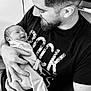 baby, man, newborn, smiling, black_and_white, beard, holding, love, family, portrait, cozy, pajamas, happy, indoor, close_up, bond, father, child, caring, affection
