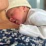 Adam a rejoint le concours — aidez-le/la à gagner de superbes lots ! newborn, baby, sleeping, hat, white_clothing, skin, person, closeup, face, head, resting, comfort, snuggling, soft, warm, floral_pattern, fabric, human, tenderness, cozy