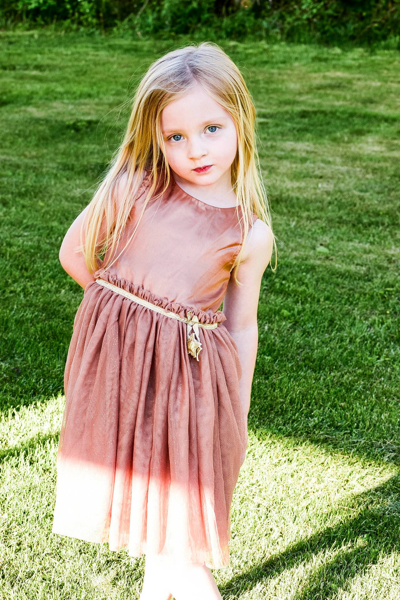 Kylee is registered to the contest to win money with this photo: baby_toddler_clothing, day_dress, dress, face, fawn, grass, hair, happy, human_body, one_piece_garment, outerwear, people_in_nature, person, photograph, pink, plant, shoulder, sleeve, toddler, tree